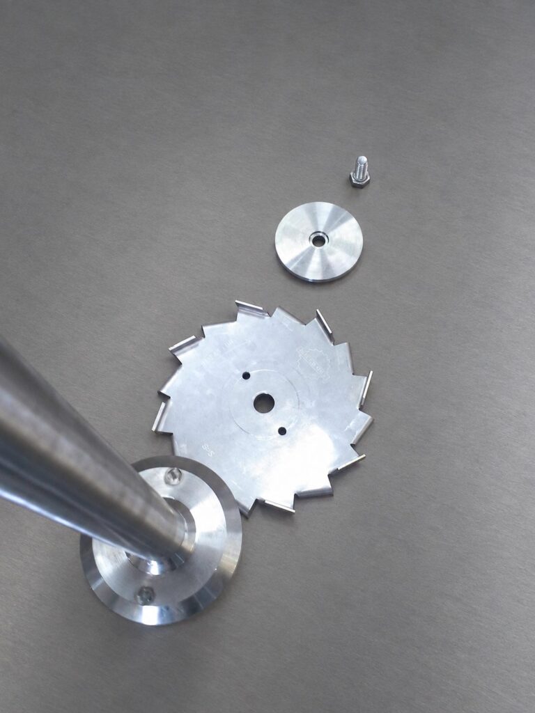 Stainless steel disperser blade and mixer shaft components.