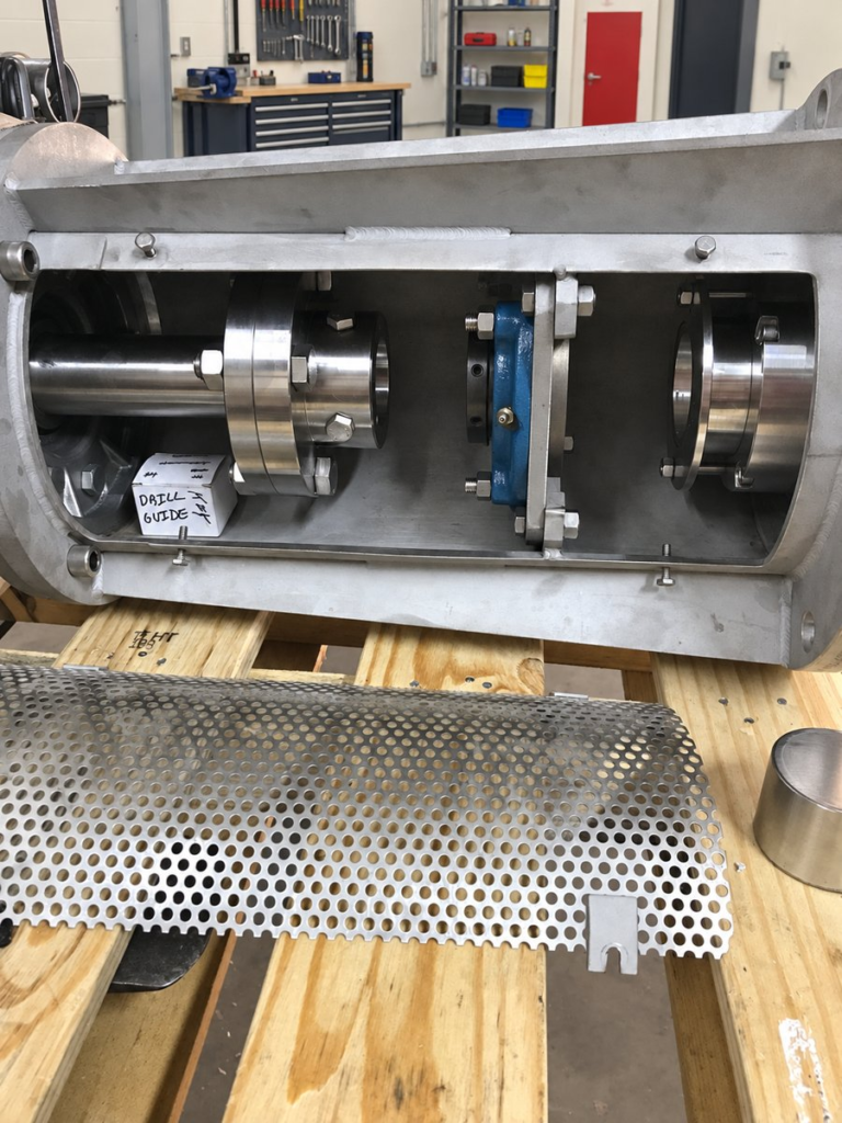 Mixer drive housing opened on a bench showing the internal shaft, bearing cartridges and seal cartridges.