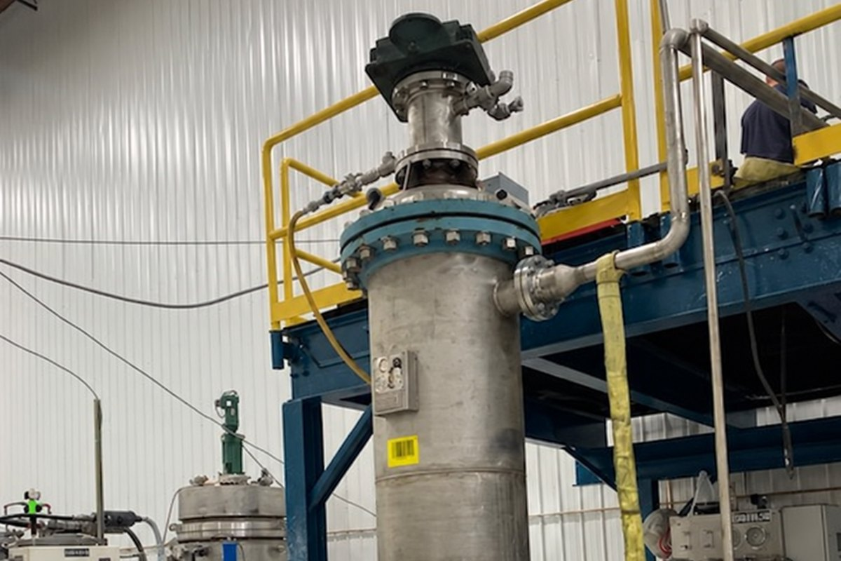 Agitation Resources top-entry mixer installed on a stainless process vessel in a plant.