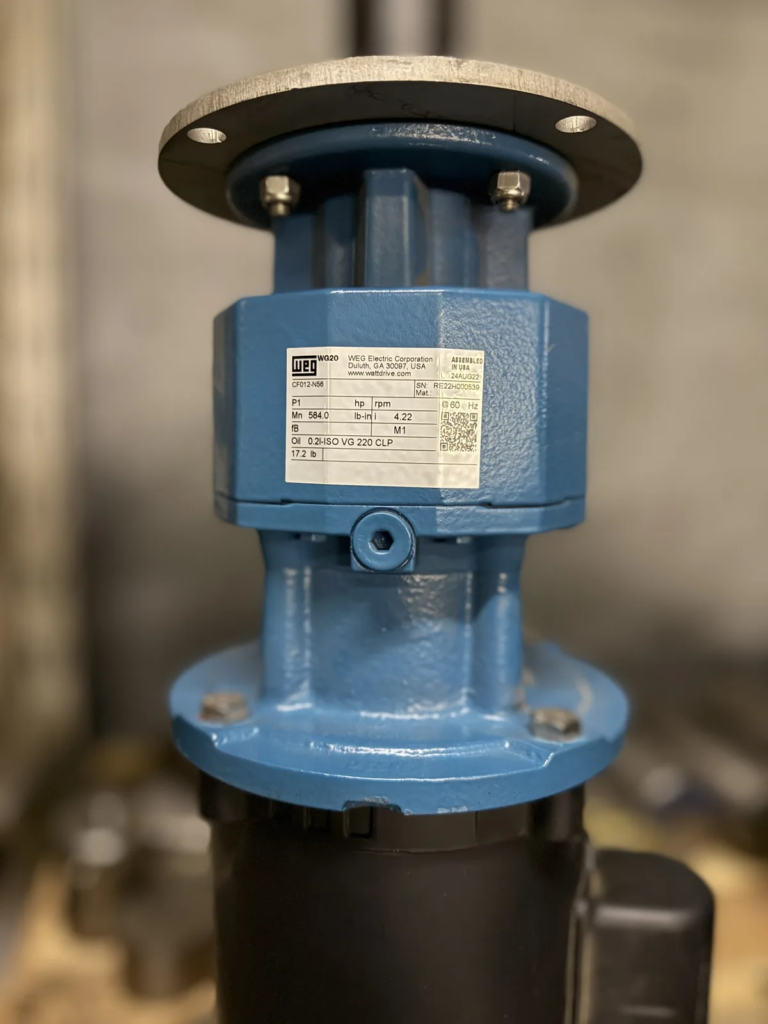 Flange-mounted WEG gearmotor on an Agitation Resources mixer drive, nameplate visible.
